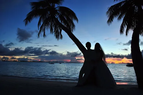Couple watching the sunset on a beach getaway